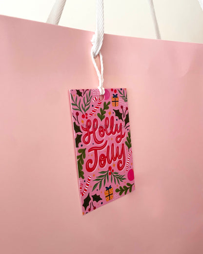Bubbly Christmas tag tied to a present-ready light pink gift bag. Showcases how the tag adds festive flair. Buy bold and modern gift tags for Christmas in Australia.