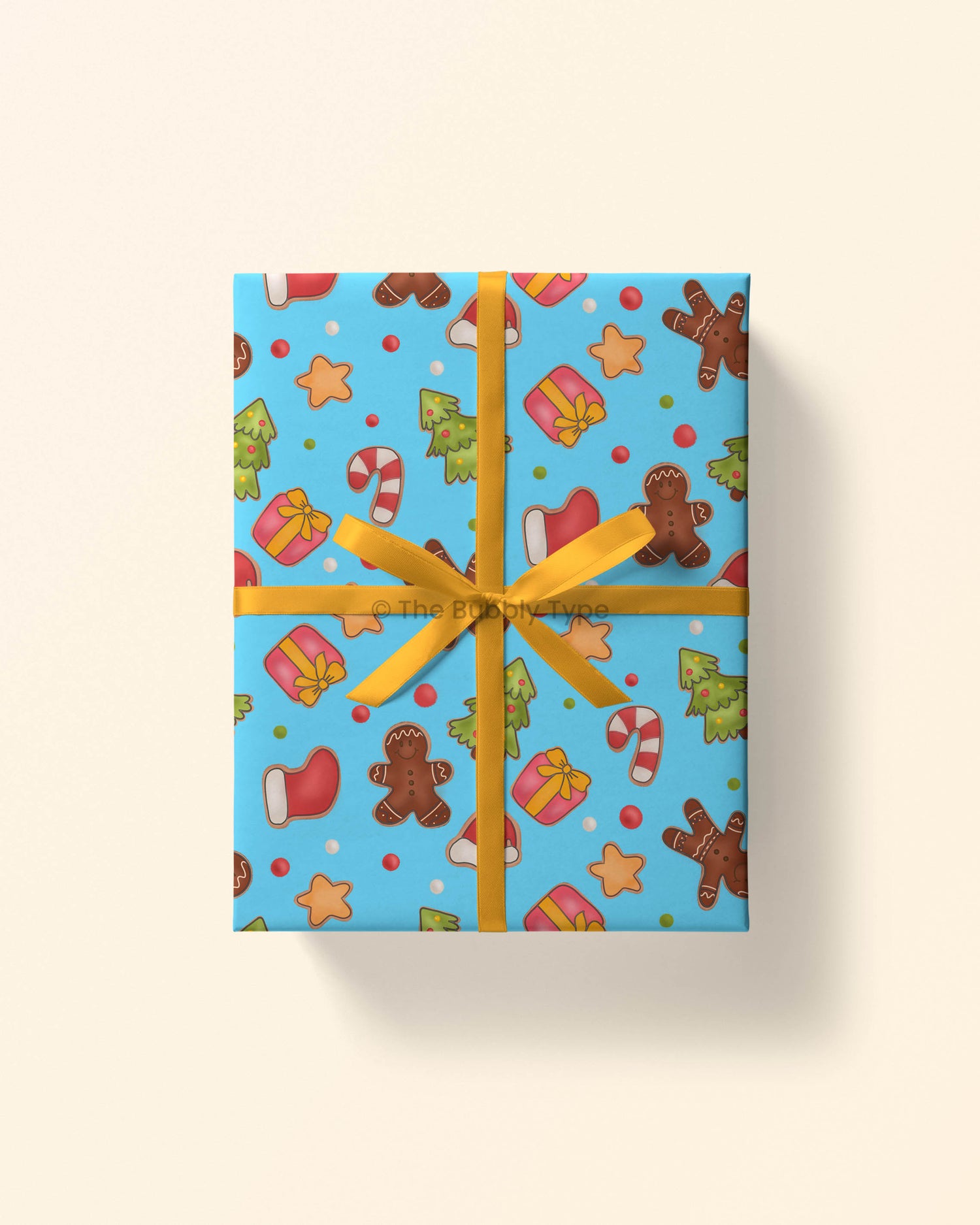 Image 1 (wrapped gift): Top view of a gift wrapped in gingerbread cookie-themed Christmas wrapping paper with cookie illustrations on a festive background.