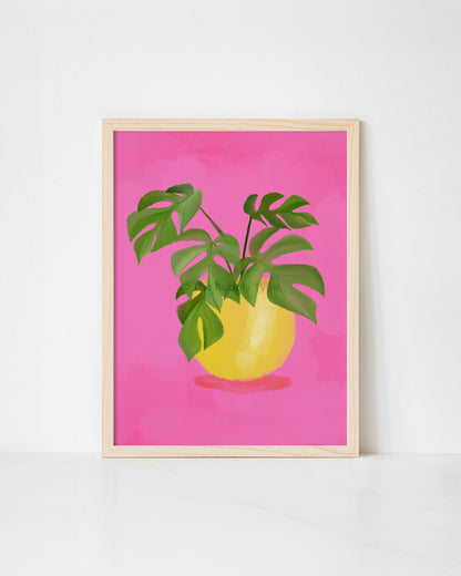 Framed artwork print of a plant with green leaves on a pink background