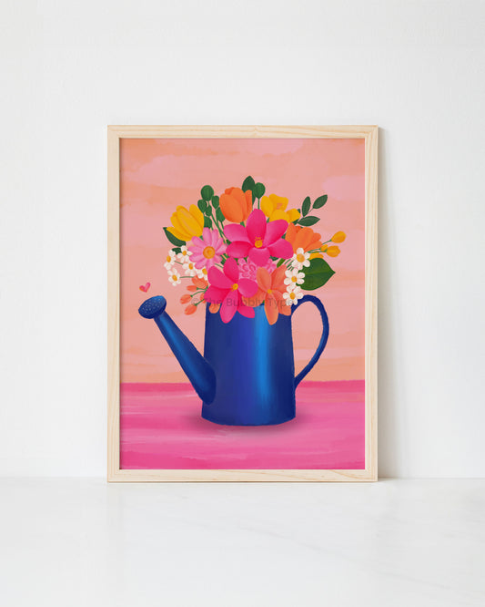 Framed artwork print of a blue watering can with colourful flowers on a pink background