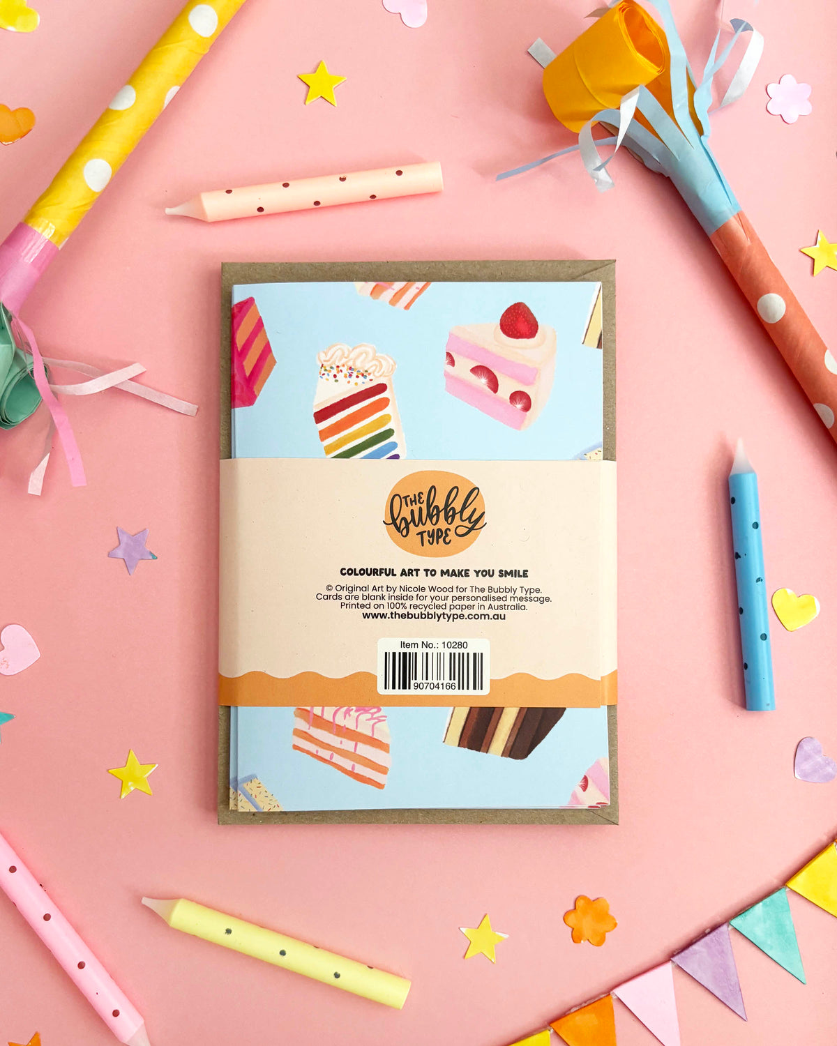 Pack of greeting cards with a pink and blue cake designs on a beige background