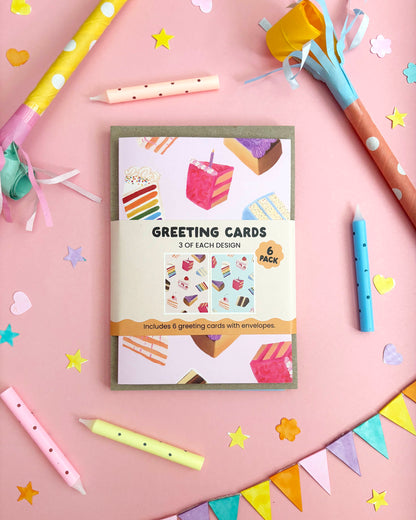 Pack of greeting cards with a pink and blue cake designs on a beige background