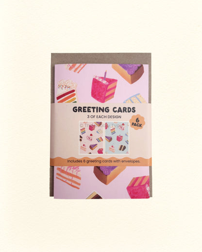 Pack of greeting cards with a pink and blue cake designs on a beige background