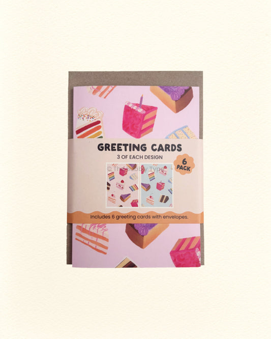 Pack of greeting cards with a pink and blue cake designs on a beige background