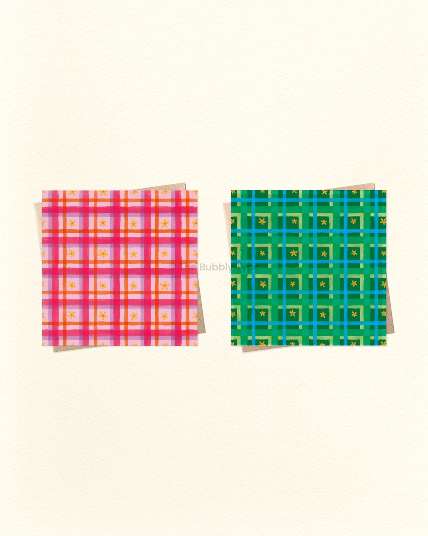 Two colourful plaid greeting cards on a beige background