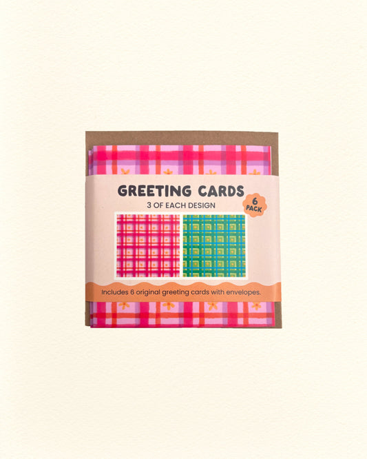 Pack of greeting cards with pink and green floral gingham designs on a beige background