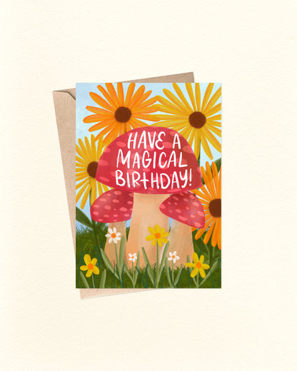 Greeting card with mushroom and sunflower design, text 'Have a Magical Birthday!', on a white background.