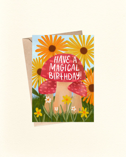Greeting card with mushroom and sunflower design, text 'Have a Magical Birthday!', on a white background.