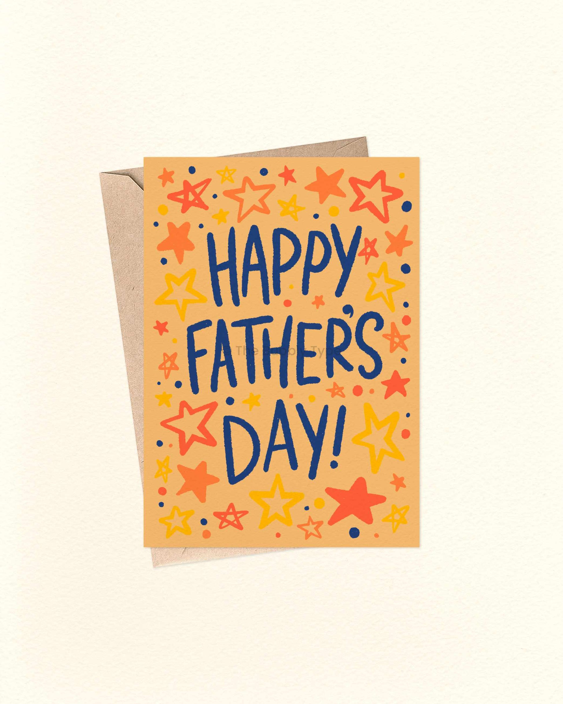 An A6 Father's Day greeting card with a kraft envelope behind it, featuring the words 'HAPPY FATHER'S DAY!' in dark blue lettering surrounded by colourful hand-drawn stars and dots on a warm orange background.