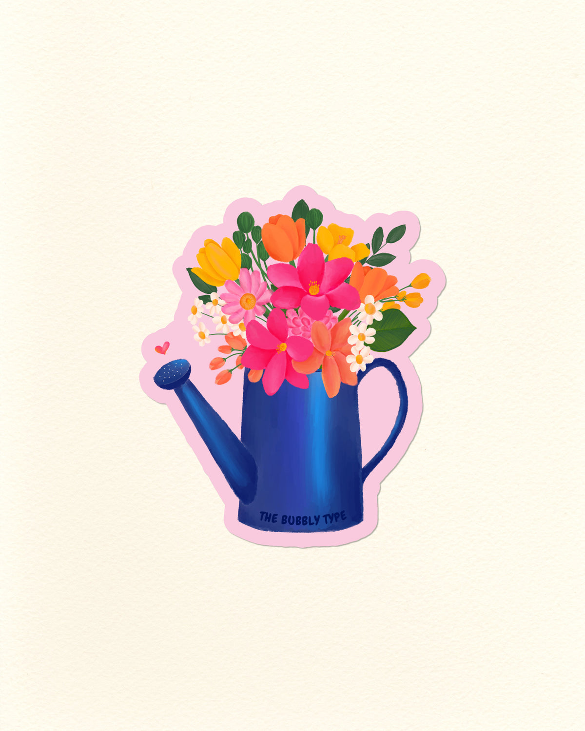 A die-cut sticker featuring a blue watering can filled with a colourful bouquet of flowers, including pink, orange, yellow, and white blossoms with green leaves. The sticker has a pink border and the text 'THE BUBBLY TYPE' printed on the can, set against a plain cream background.