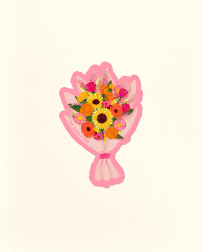 A die cut vinyl sticker with stylised illustration of a bouquet of colourful flowers wrapped in pink paper, centred on a plain off-white background.