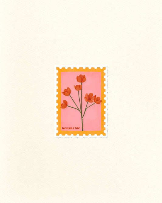 A vinyl die cut sticker of a postage stamp featuring orange Californian poppies flowers on a pink background with a yellow-orange border, centred on a warm off-white textured backdrop. Small text at the bottom reads 'THE BUBBLY TYPE'.