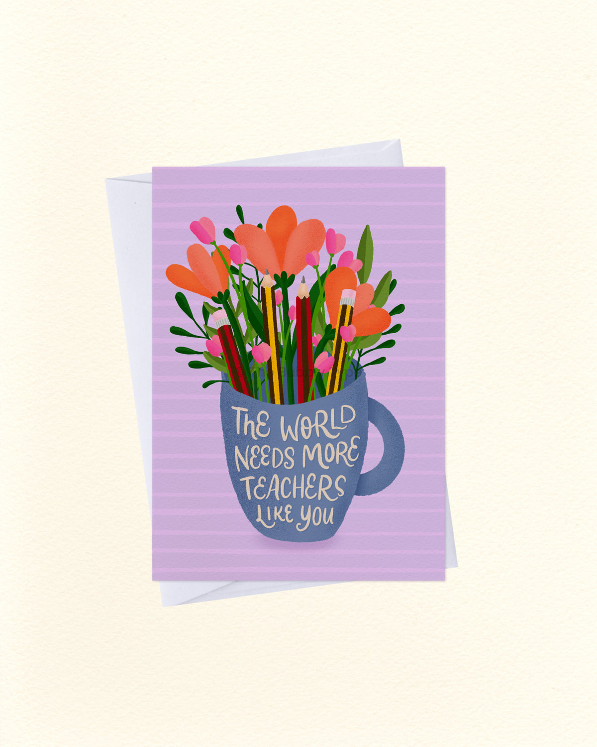 A greeting card with a lavender striped background featuring an illustration of orange flowers, pink blossoms, and colorful pencils emerging from a blue mug. The mug has the text 'THE WORLD NEEDS MORE TEACHERS LIKE YOU' written on it.