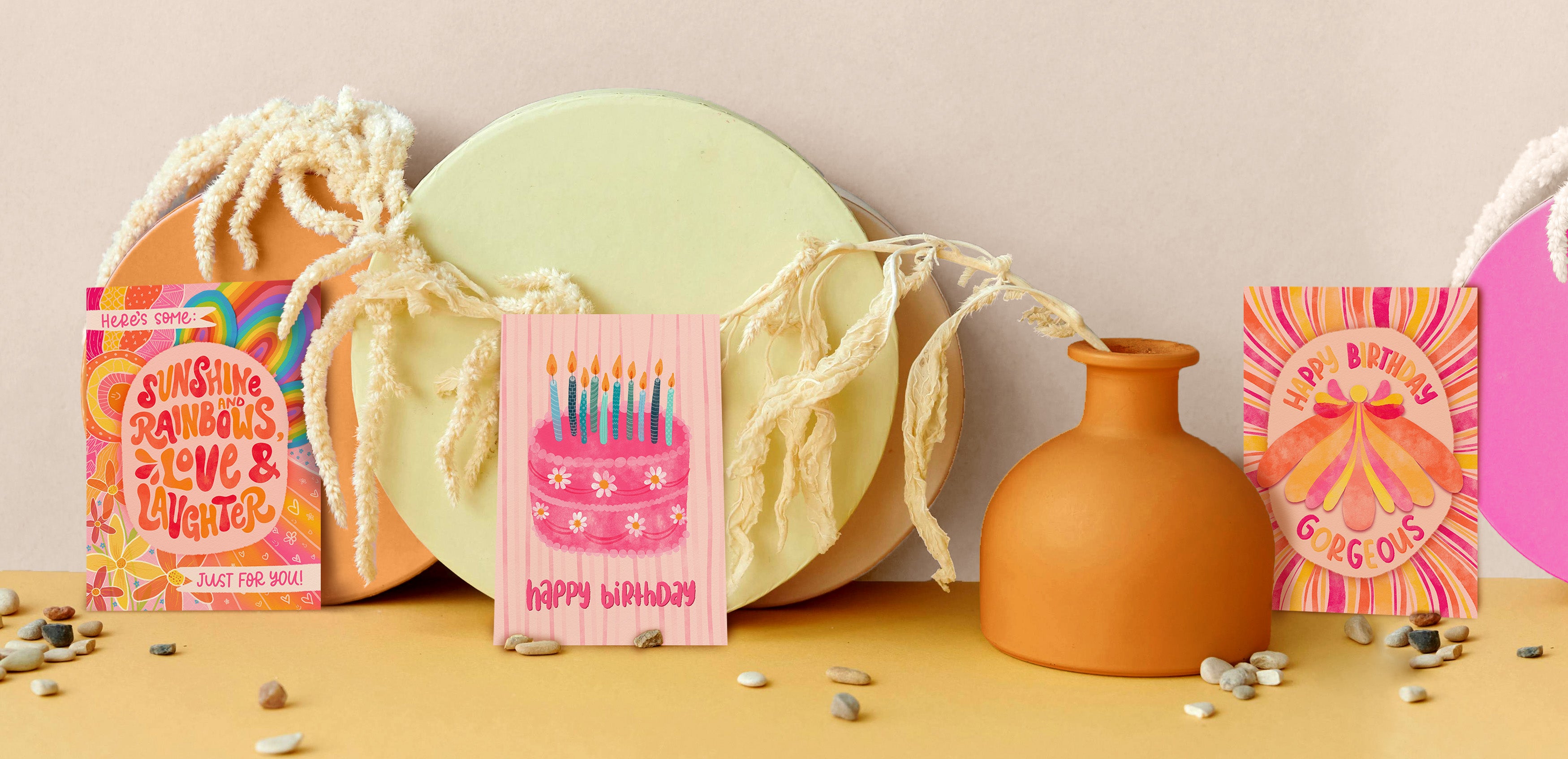 Birthday Greeting Cards made in Australia by The Bubbly Type. 2 vibrantly coloured original designs are showcased amongst circular photo props.