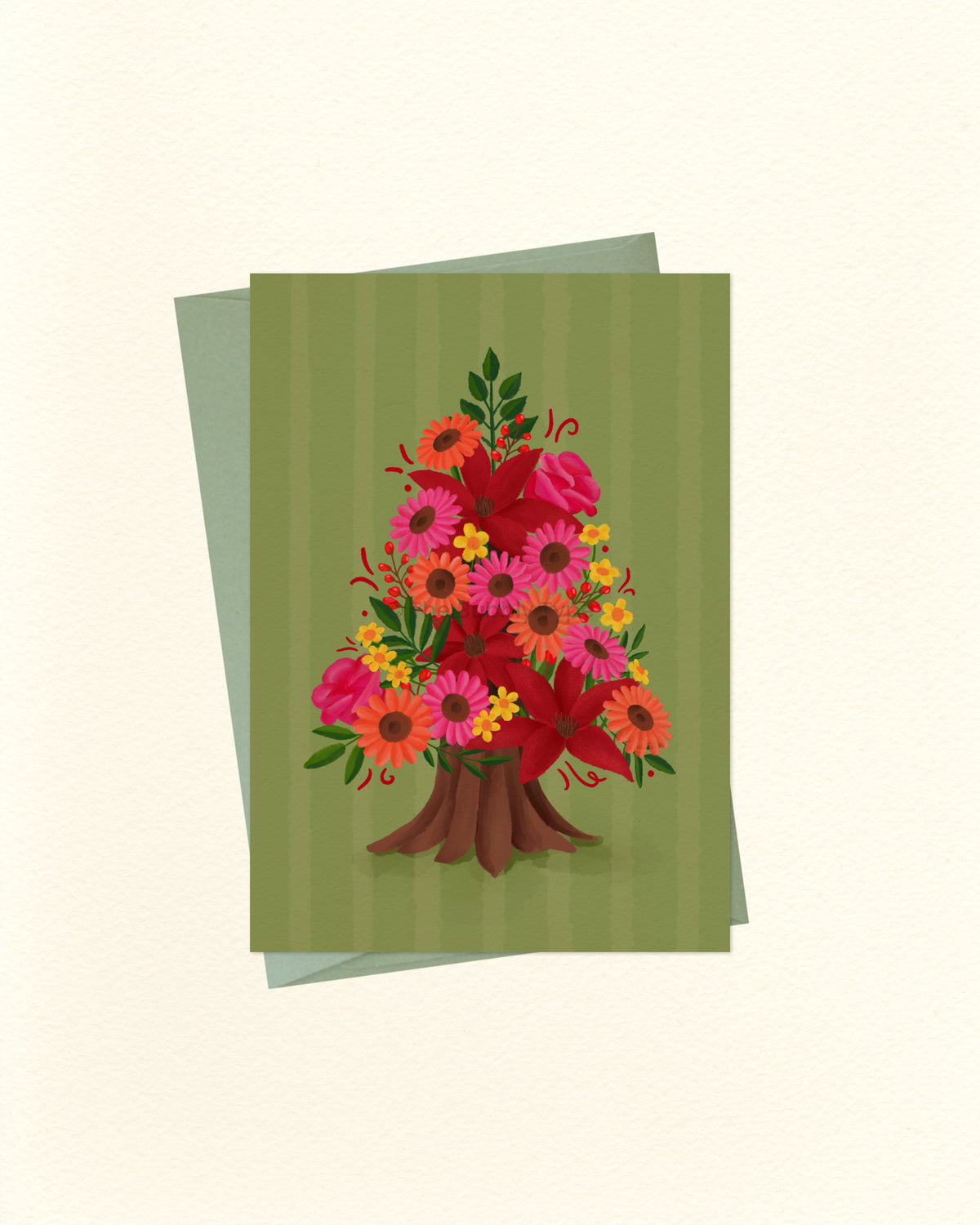 A greeting card featuring a colorful bouquet of flowers arranged in the shape of a tree, set against a striped olive green background, with a matching green envelope behind it on a cream-colored surface.