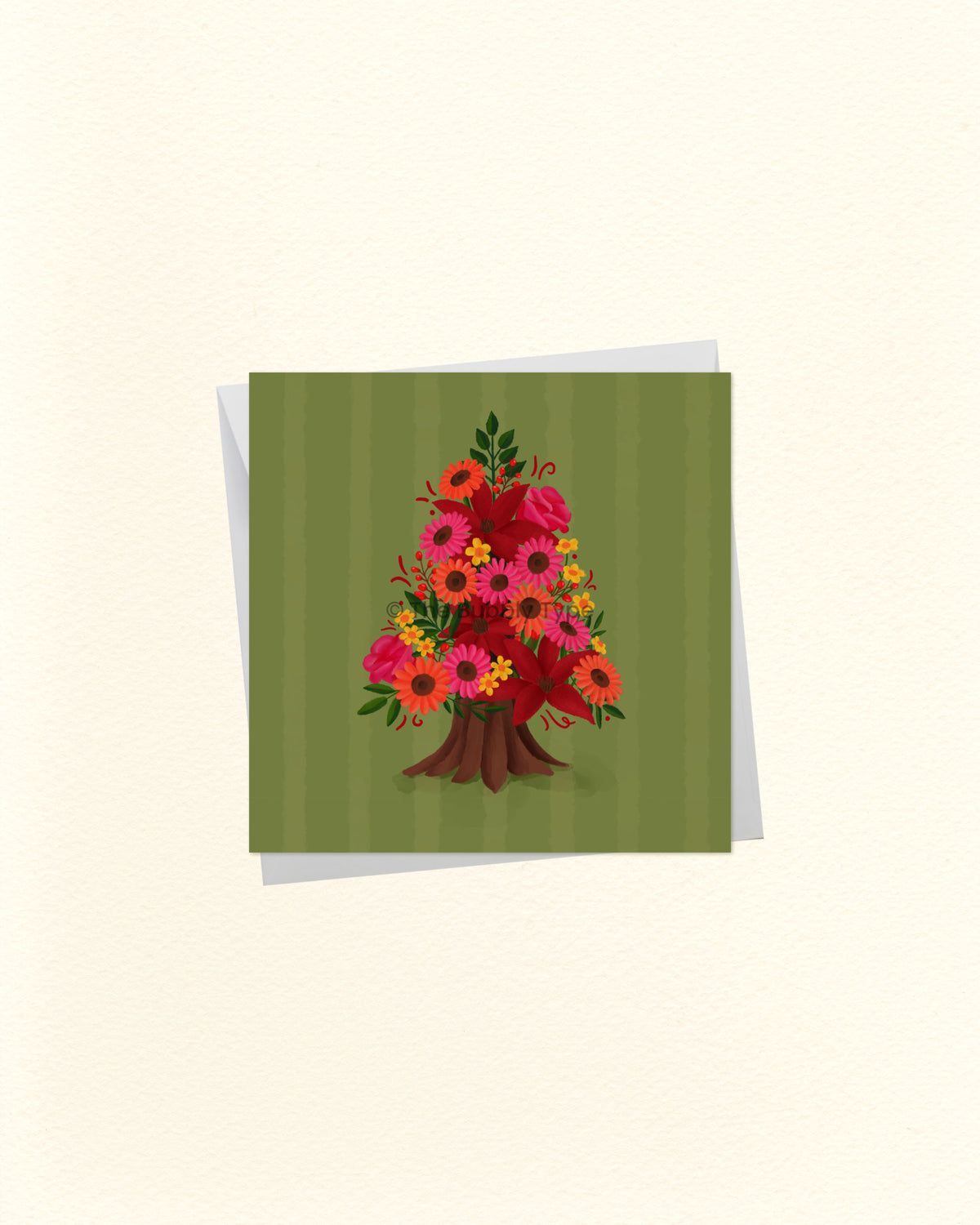 A square greeting card with a green striped background and a colourful floral tree illustration in the centre, shown with a white envelope behind it on a light cream background.