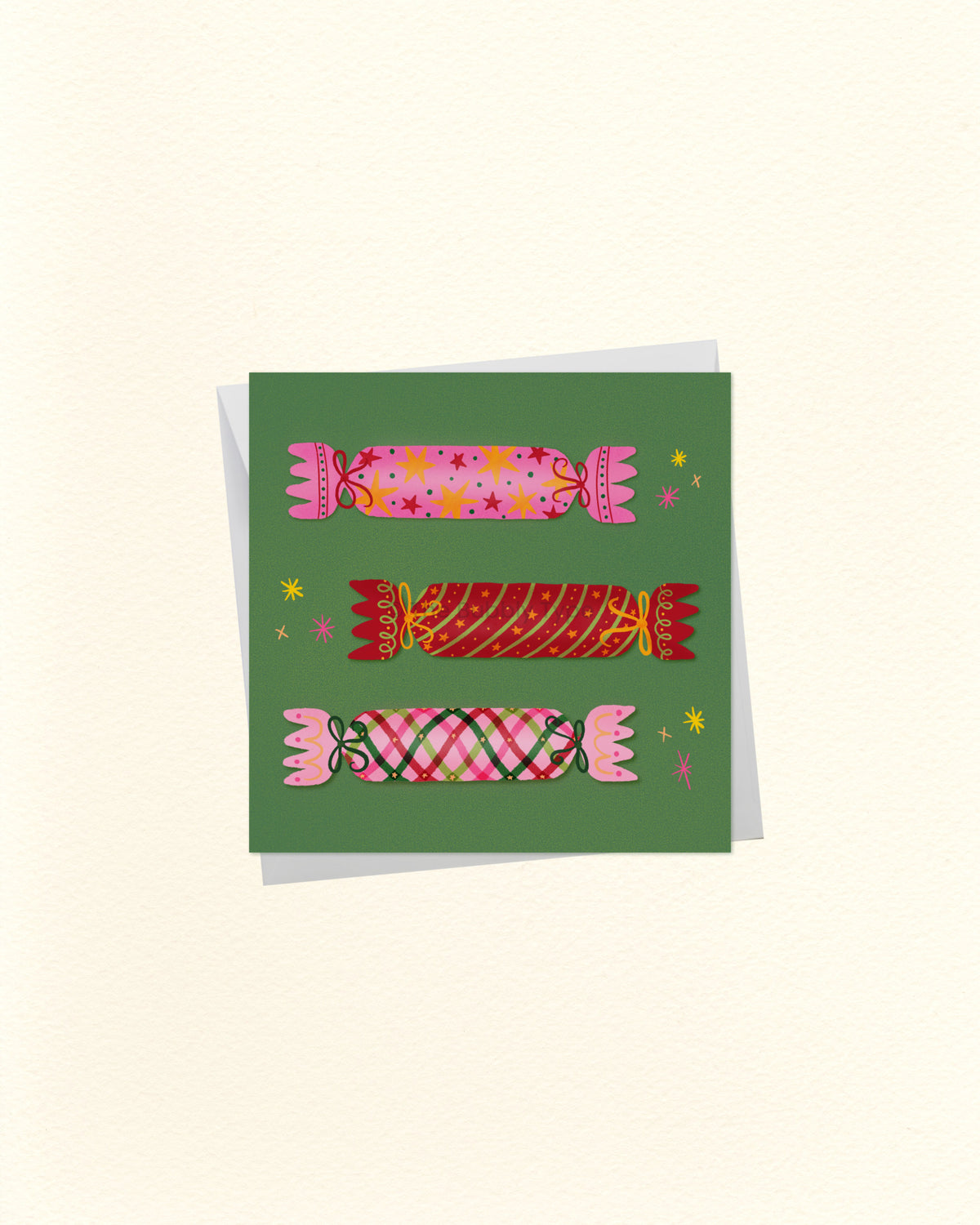 A square art print or card featuring three stylized pink and red candy illustrations on a muted green background, shown against a warm off-white backdrop with a soft shadow.