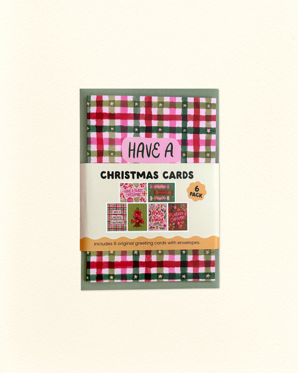 A package of 6 Christmas cards featuring festive red, green, and pink plaid patterns, shown on a light cream background.