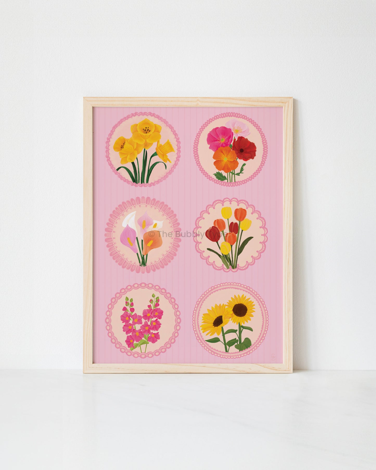 Framed artwork with floral illustrations on a pink background