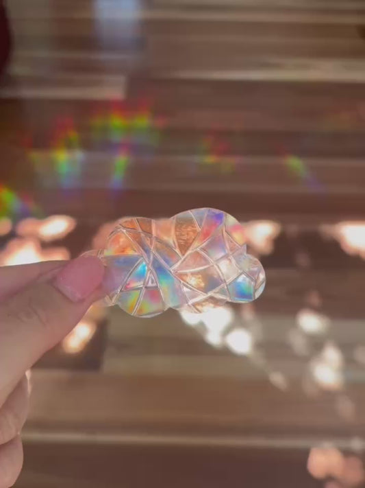 Cloud shaped sun catcher with rainbows shown in the background.